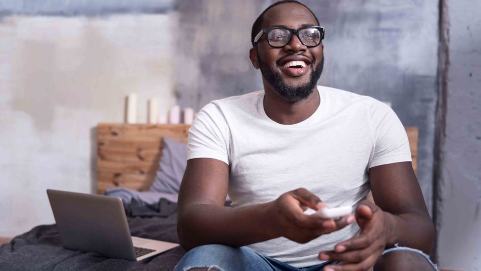 A young man watching TV. (Shutterstock)