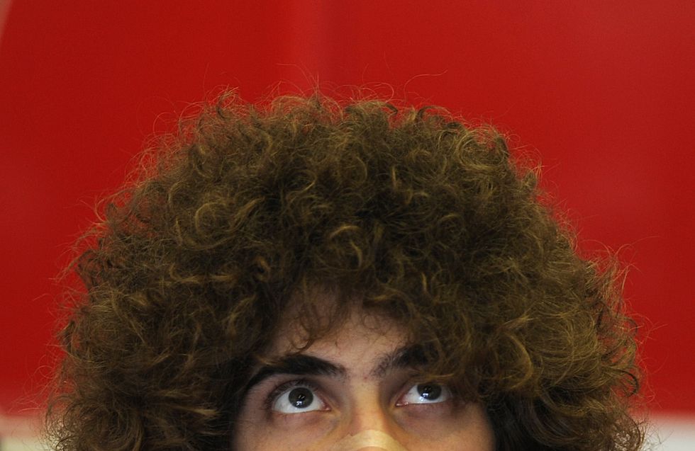 White man with big, puffy hair.