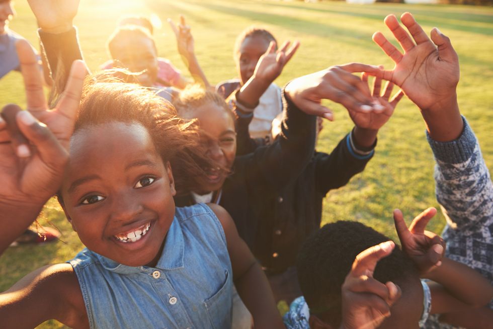 Black school kids looking happy. Shutterstock.