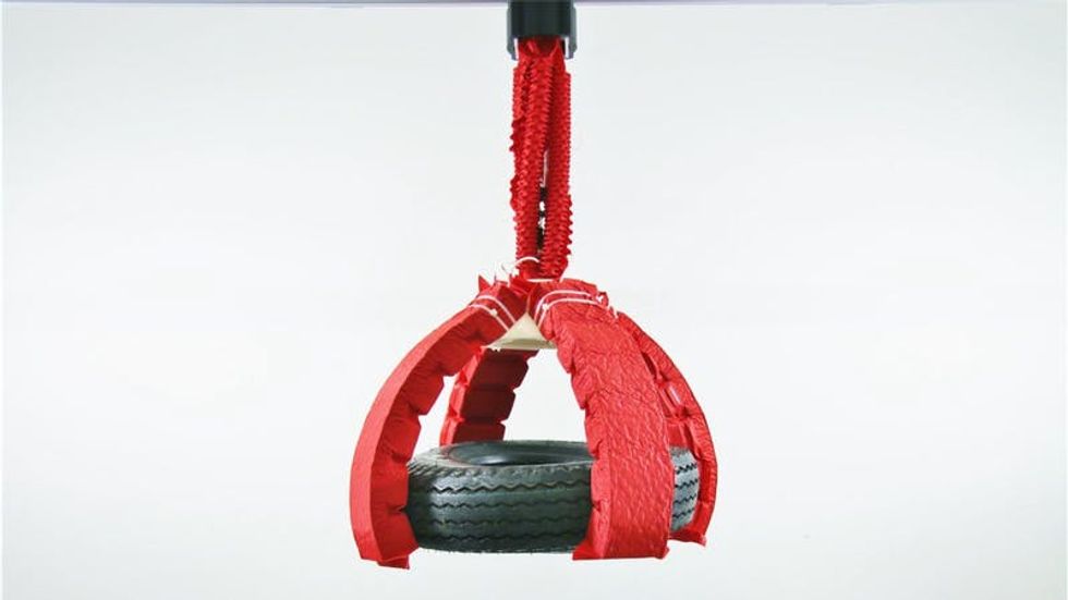 Soft robot lifting a tire.