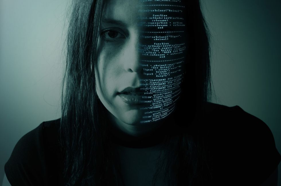 Girl's face, half in code.