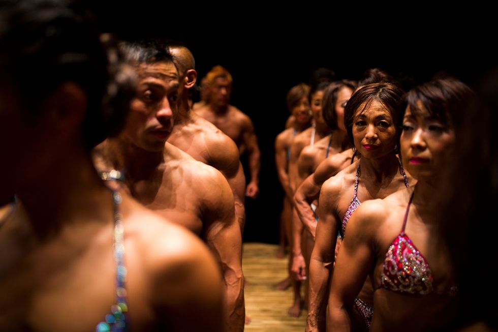 Men and women at a body building competition in Japan.