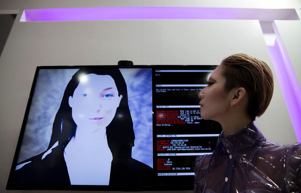 Woman looks at A.I. on a screen.