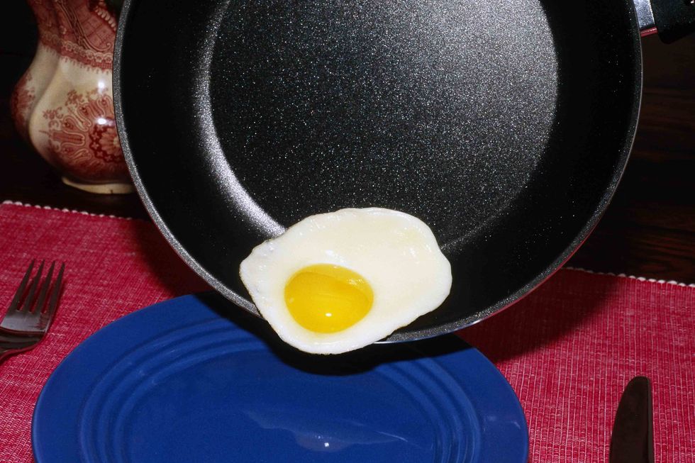 An egg sliding out of a non-stick frying pan. (Getty Images)