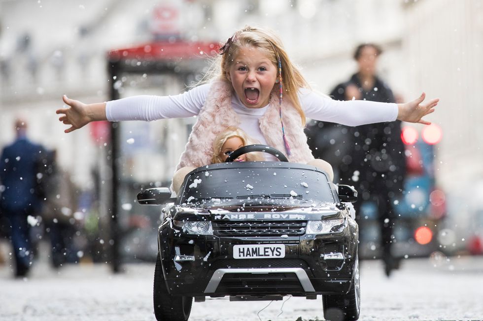 Girl in a toy car. Credit: Getty Images.