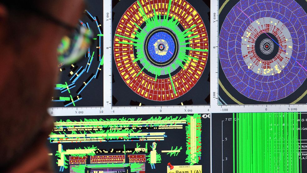 Particle physicists fired up the world's biggest atom-smasher in a mission to answer some of the most perplexing questions about the nature of the Universe. (FABRICE COFFRINI/AFP/Getty Images)