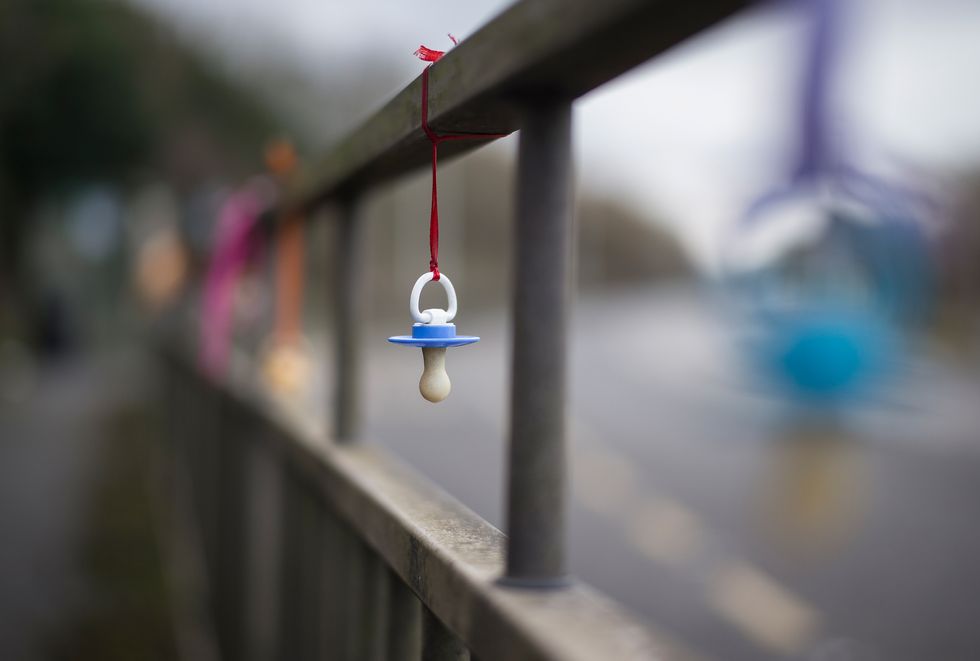 A pacifier hanging on a string.