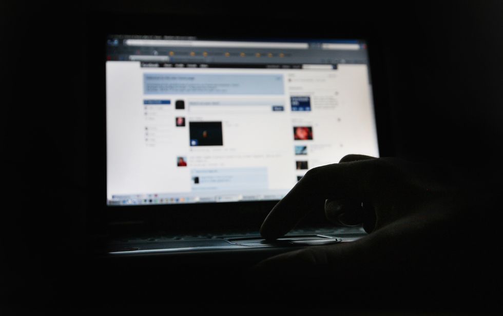 A person using social media in the dark.