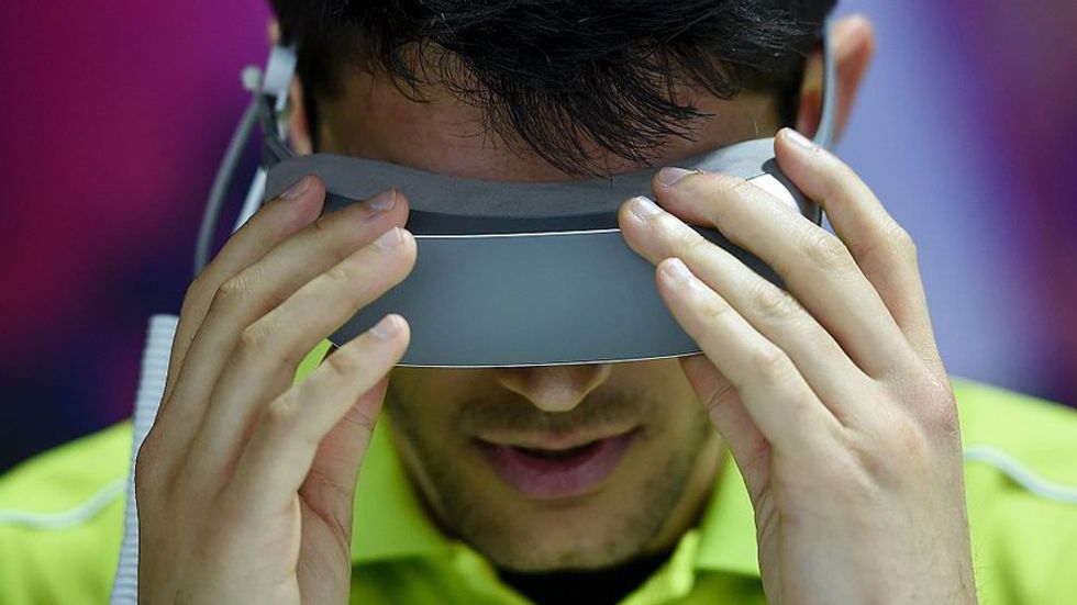 A man puts on a VR headset. (Photo: JOSEP LAGO/AFP/Getty Images)