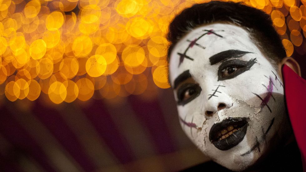 A man with costume make up looks on at a Halloween party in Yangon on October 31, 2014. Halloween, a contraction of All Hallows' Eve, is celebrated on the last day of October before All Saints Day. (Photo: Ye Aung Thu/AFP/Getty Images)
