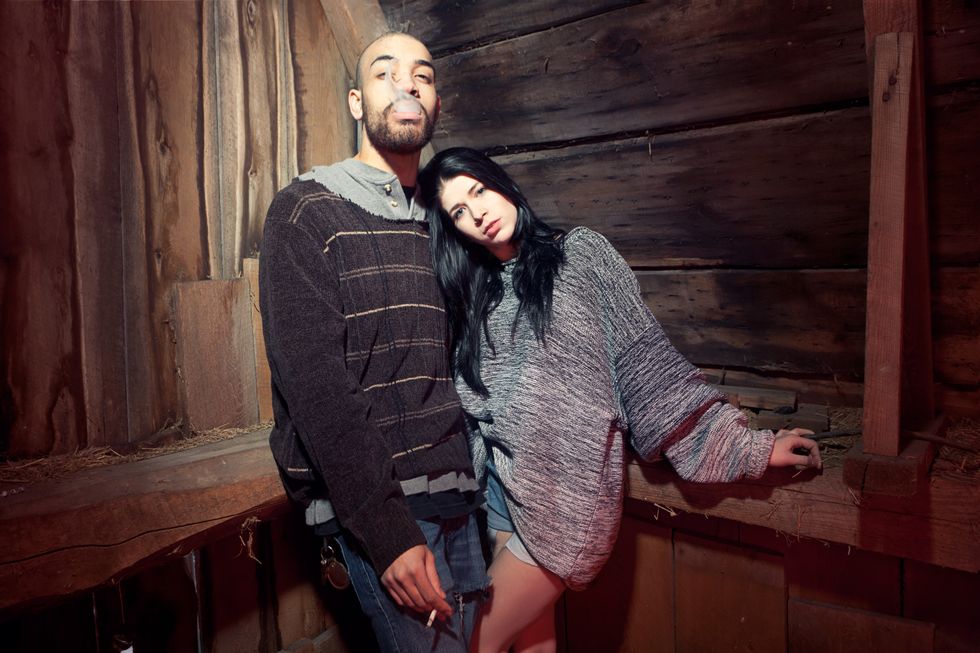 Portrait of young couple in barn while man smoking. (Thierry Lord/Getty Images)