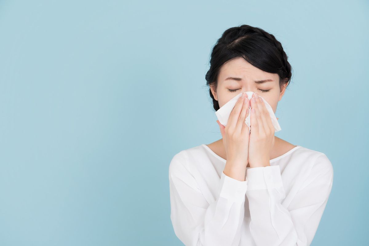 a woman sneezing 