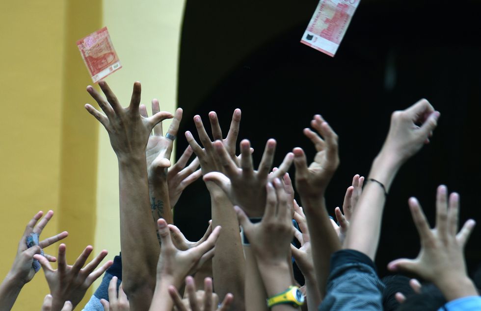 People jumping up into the air to catch money.