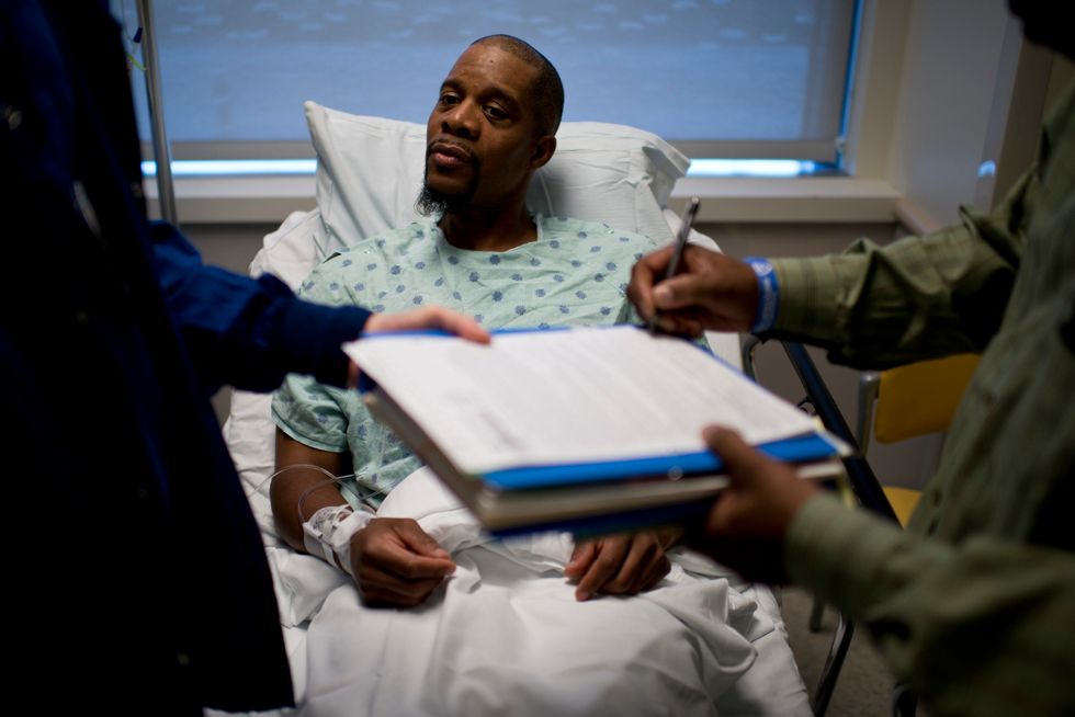 Patient siting in a hospital bed.