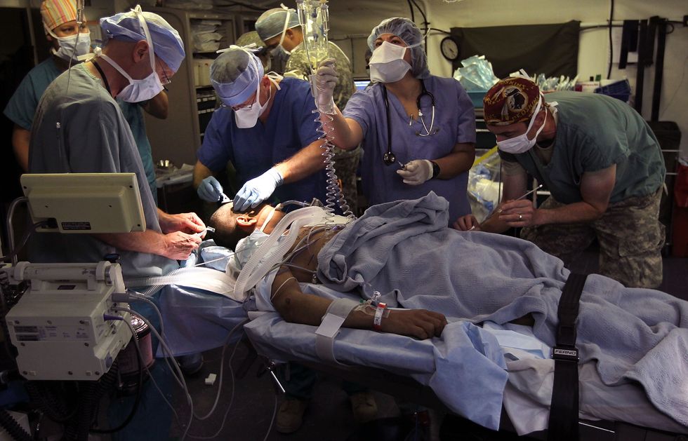Team preparing a patient for brain surgery.