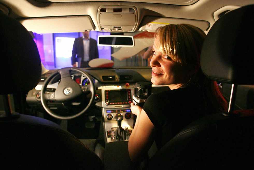Woman in a driverless car.