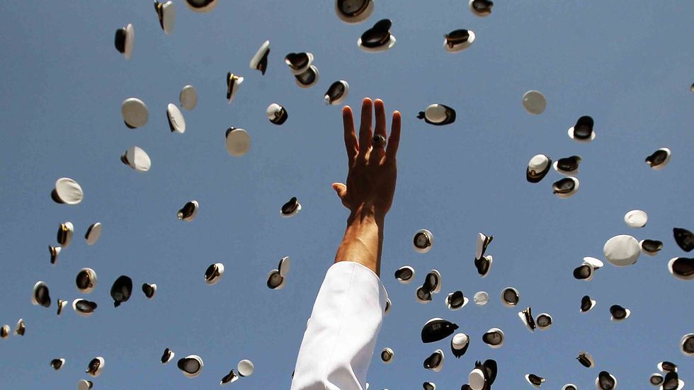 U.S. Naval Academy graduates throw their hats in the air during graduation ceremonies at the U.S. Naval Academy in Annapolis, Maryland. (Photo by Mark Wilson/Getty Images)