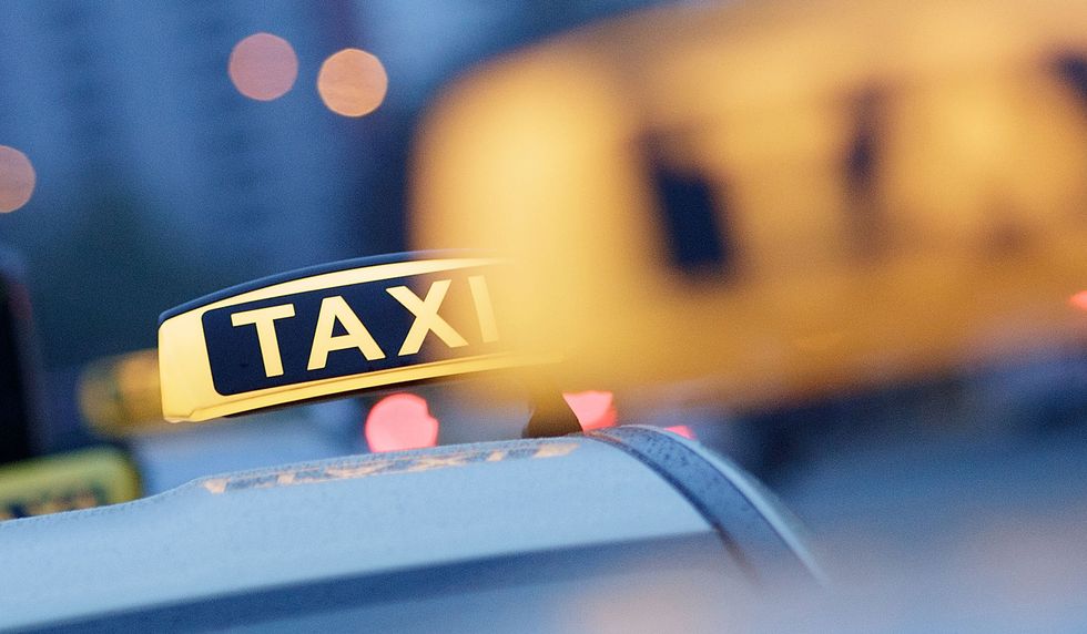 A fleet of yellow and blue taxis.