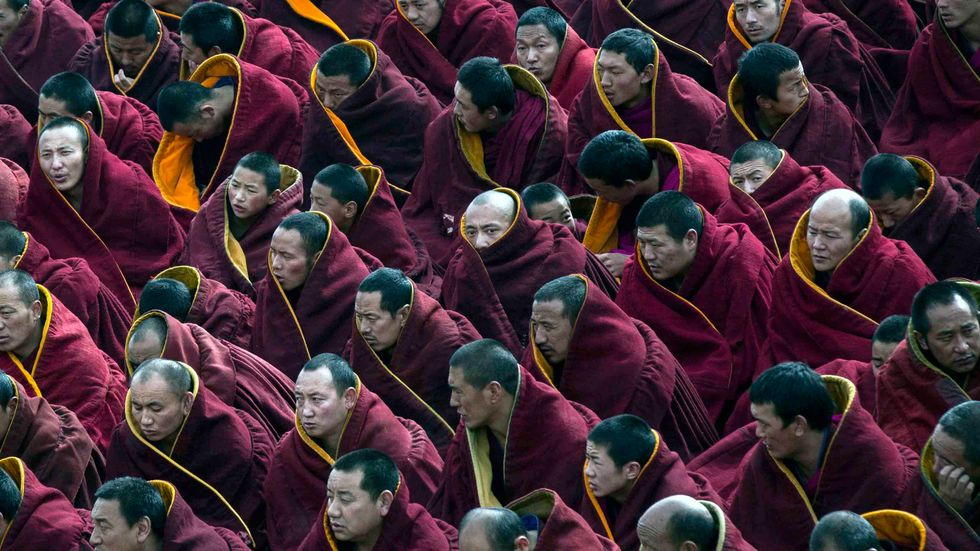 Tibetan Buddhist monks take part in a special prayer during Monlam or the Great Prayer rituals at the Labrang Monastery, Xiahe County, Amdo, Tibetan Autonomous Prefecture, Gansu Province, China. (Photo by Kevin Frayer/Getty Images)
