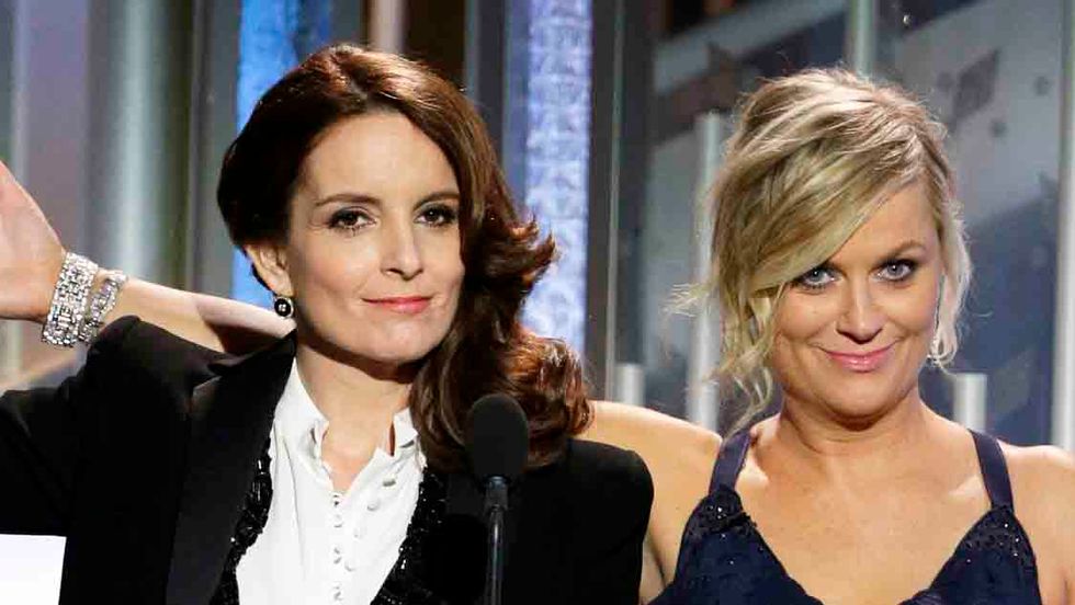 Hosts Tina Fey and Amy Poehler speak onstage during the 72nd Annual Golden Globe Awards at The Beverly Hilton Hotel on January 11, 2015 in Beverly Hills, California. (Paul Drinkwater/NBCUniversal via Getty Images)
