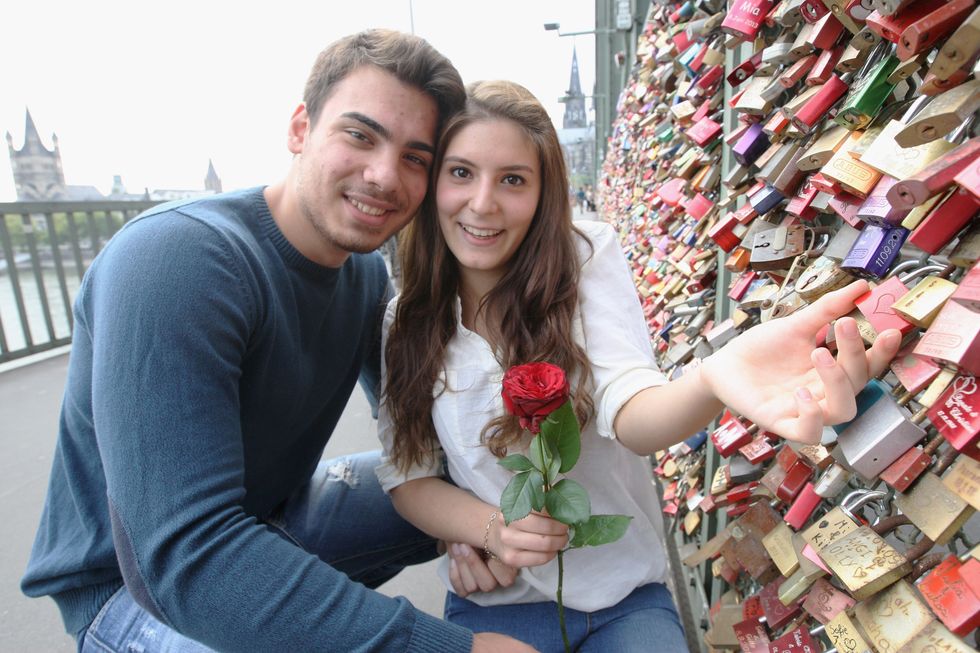 Cute couple has their love lock on a bridge.