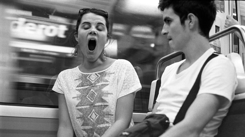 A woman yawning, sleep deprived