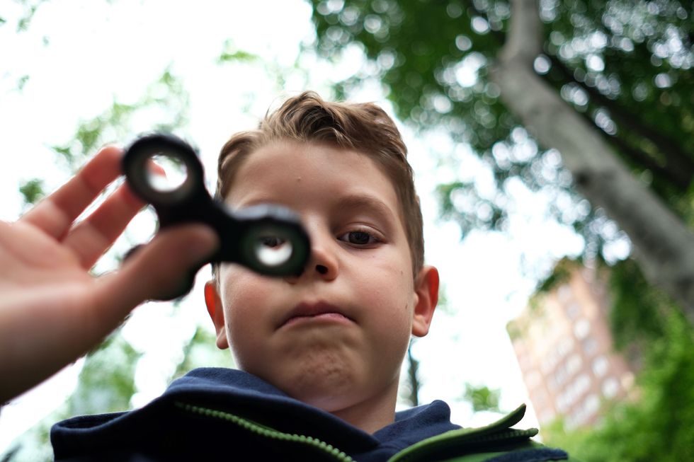 Little boy with a fidget spinner.