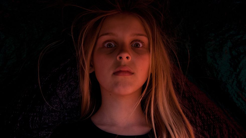 A girl who has just seen a ghost.