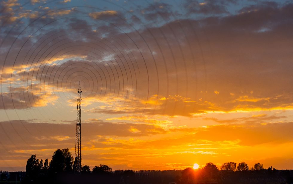 picture of cell tower in the sunset