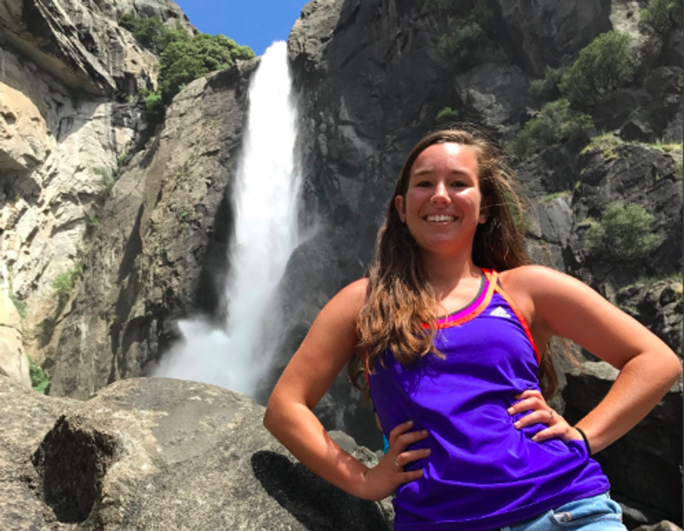 mollie tibbetts in front of waterfall