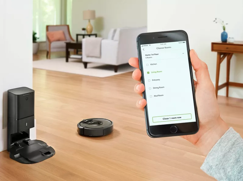 Picture of smartphone with Roomba app controlling iRobot Roomba smart vacuum.