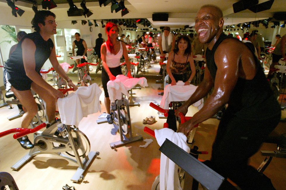 a multiracial group of athletes doing intense cycling