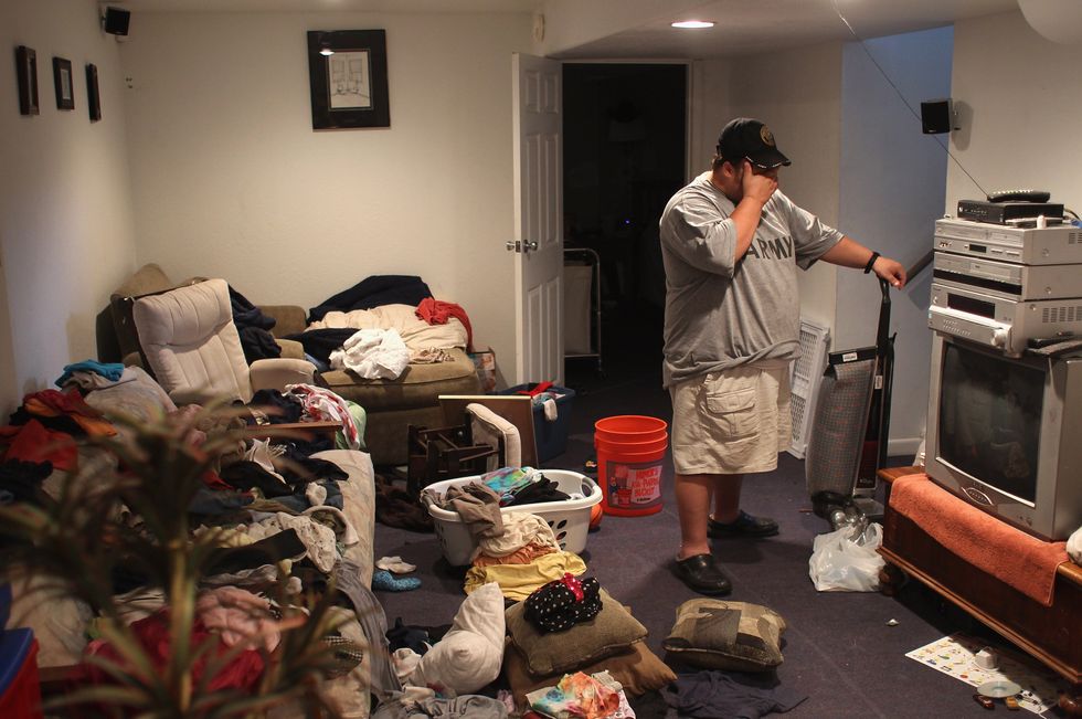 Man with PTSD in messy house.