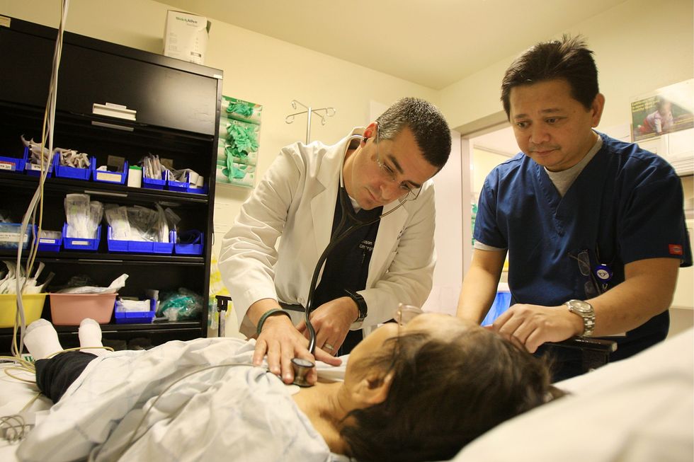 Doctors work on woman.