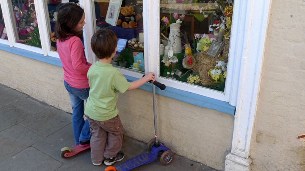 Children looking at toys through a shop window