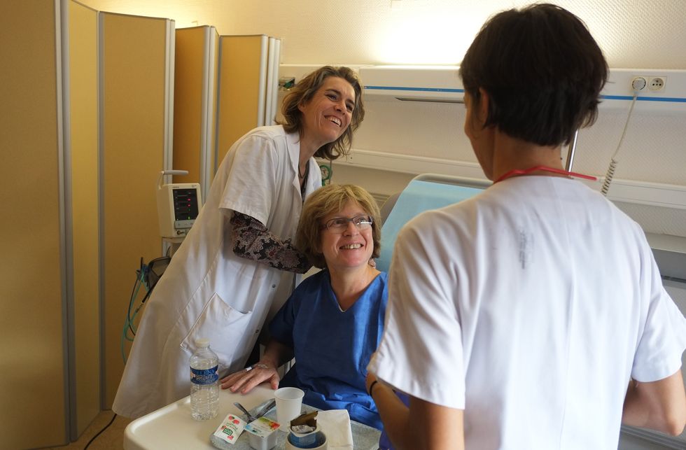 Nurse and doctor cheer a patient up.