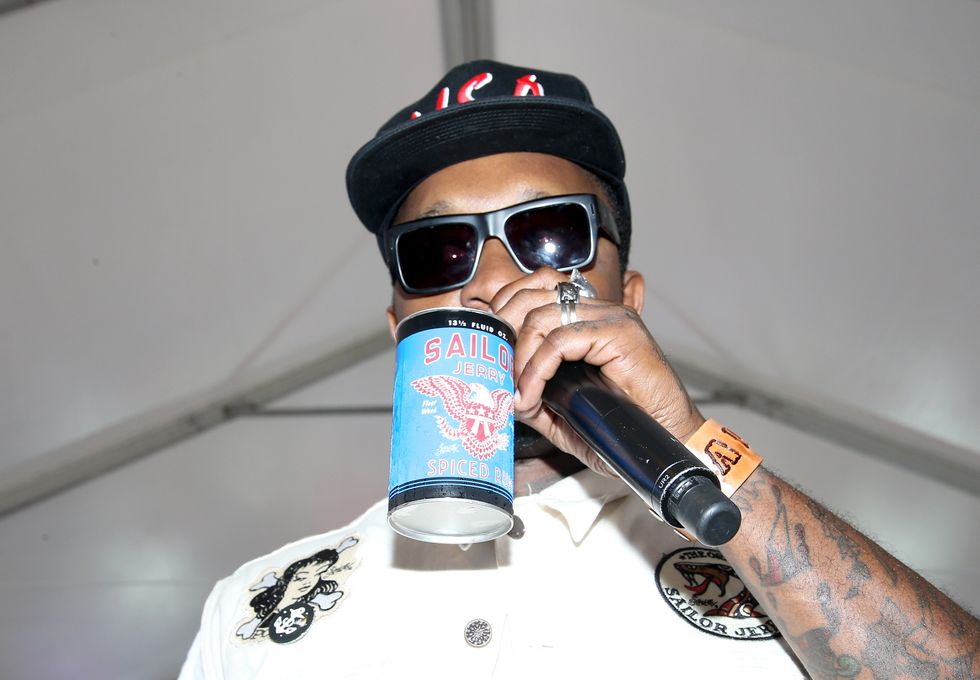 A rap artist drinking a brand of alcohol on stage
