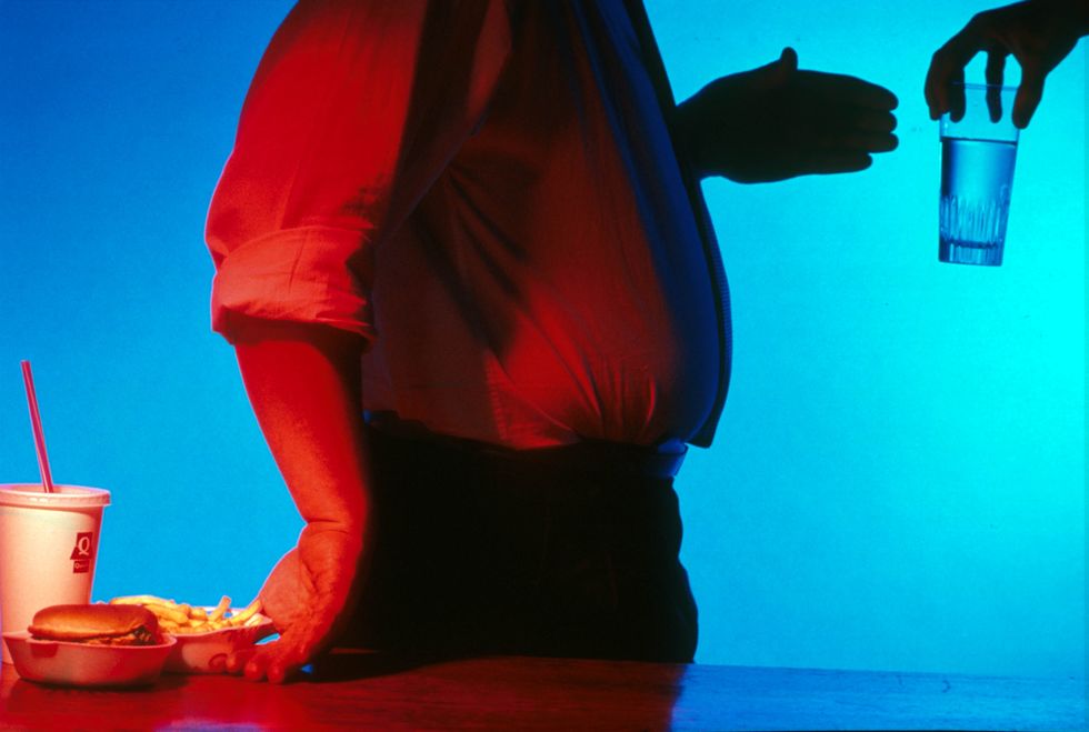 Obese man turns back on fast food, chooses water instead.