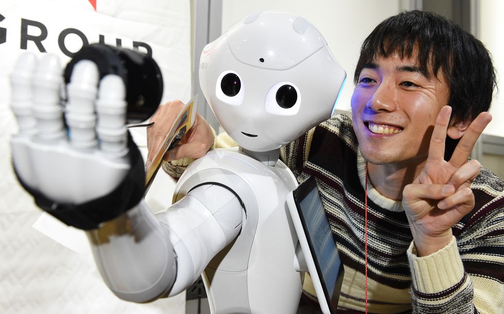 Robot Pepper takes a photo with a human.