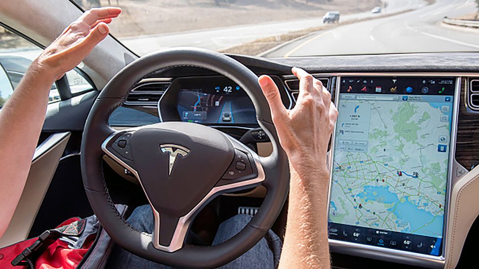 A member of the media test drives a Tesla Motors Inc. Model S car equipped with Autopilot in Palo Alto, California.