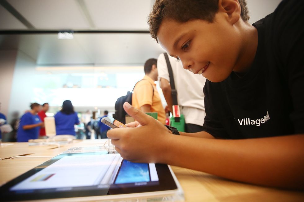 Boy using a smartphone and tablet.