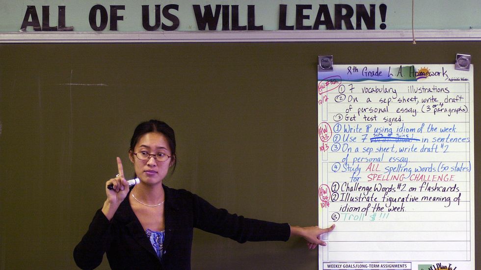 A teacher at KIPP Academy in the Bronx, NY — a school known for being strict and giving students 2 hours of homework each night. (Chris Hondros/Newsmakers)