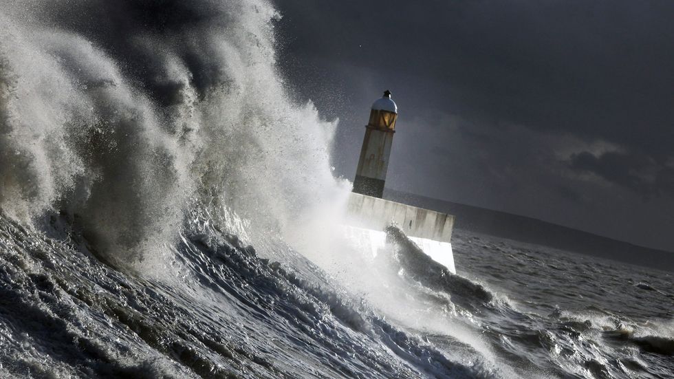 Waves batter the harbour wall on November 22, 2009 in Porthcawl, Wales. (Photo by Matt Cardy/Getty Images)