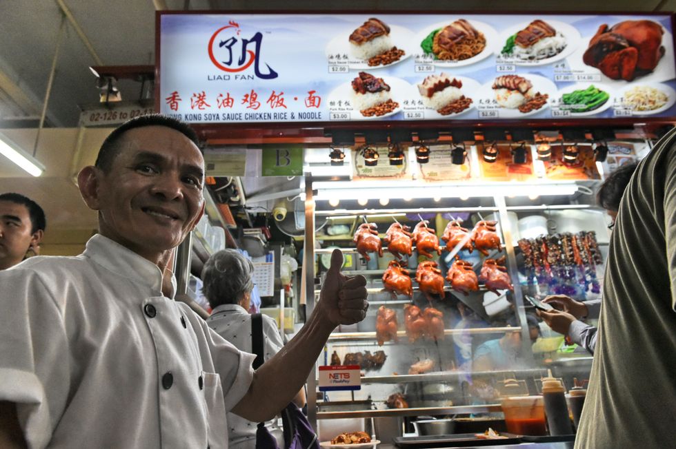 Singaporean chef Chan Hon Meng poses in front of his Hong Kong Soya Sauce Chicken Rice and Noodle stall in Singapore. (Photo credit ROSLAN RAHMAN/AFP/Getty Images)