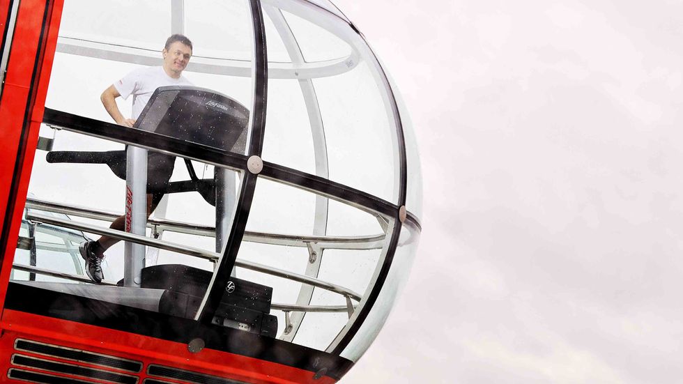 Veteran marathon runner Noel Bresland attempts to run a marathon on a treadmill inside a capsule of the famous London Eye in central London.