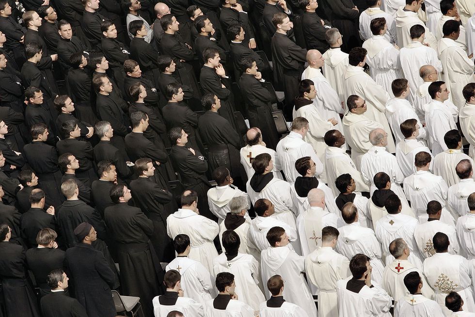 Priests attend a special mass for Pope John Paul II in St Peter's Square on April 3, 2005, in Vatican City. (Photo by Peter Macdiarmid/Getty Images)