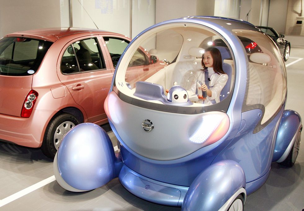 Japan's auto giant Nissan unveils the new robotic vehicle 'Pivo 2', equippeec with in-wheel electric motors to drive all wheels independently and to pivot its cabin at the company's headquarters in Tokyo. (Photo: YOSHIKAZU TSUNO/AFP/Getty Images)