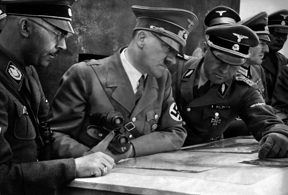 Hitler deciding strategy with his generals around him.