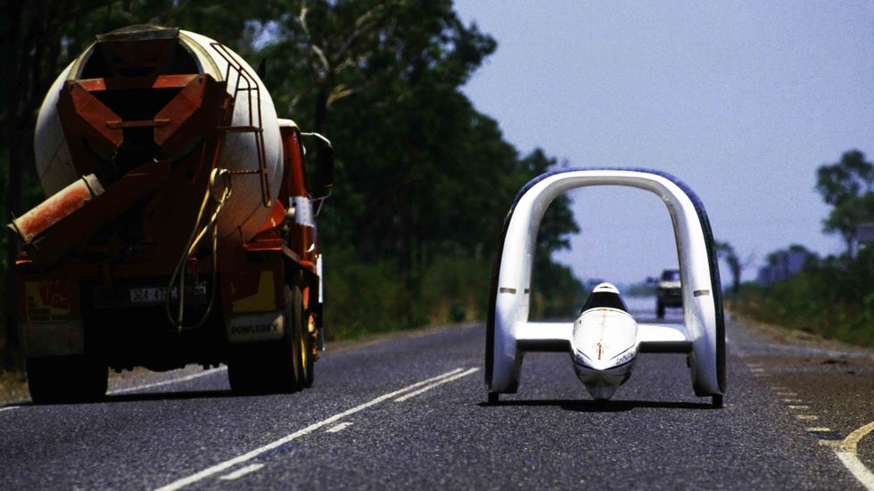 A solar-powered car designed by Jonathan Tennyson drives on Stuart Highway during the inaugural Darwin to Adelaide Pentax World Solar Challenge race.