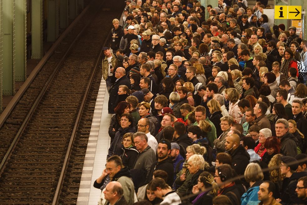 Passengers crowd the platform as they wait for the subway train. Photo by Carsten Koall/Getty Images